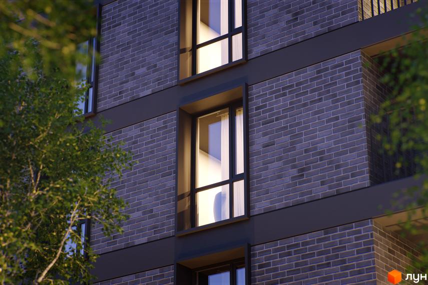 Новобудова Avalon Time з темної цегли та великими вікнами. Зовнішній вигляд будівлі з елементами дизайну.