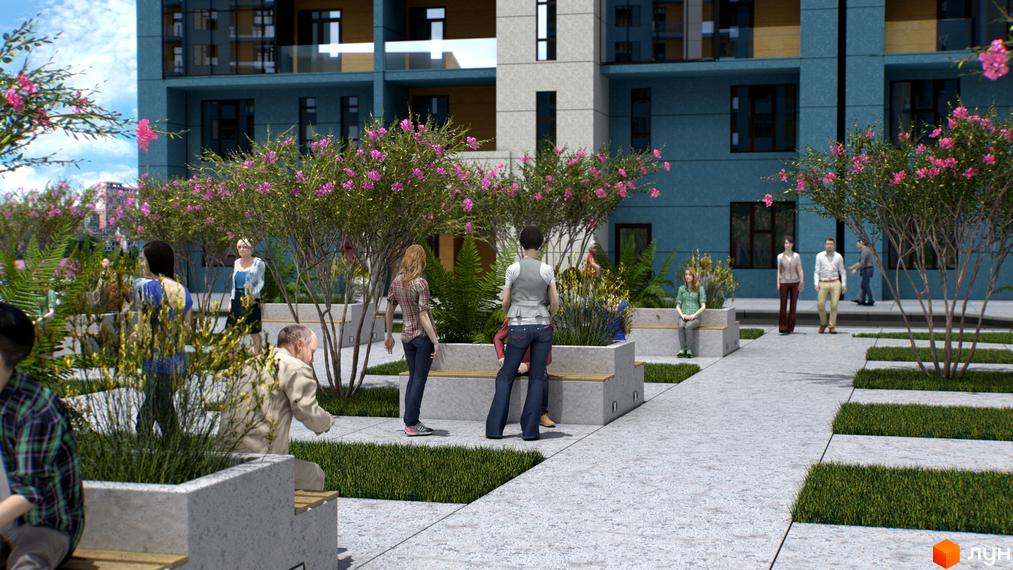 Житловий комплекс Національний. Фасад житлового будинку блакитного кольору з великими вікнами. На прибудинковій території алея з лавками та декоративними деревами.