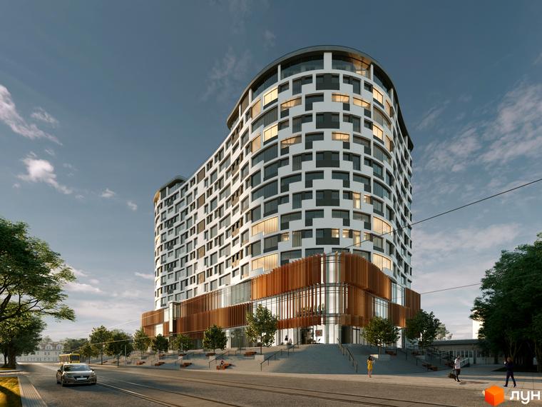 Житловий комплекс Президент Хол - це вигнута будівля з білим фасадом та темними вікнами, розташована біля дороги з трамвайними коліями та деревами.