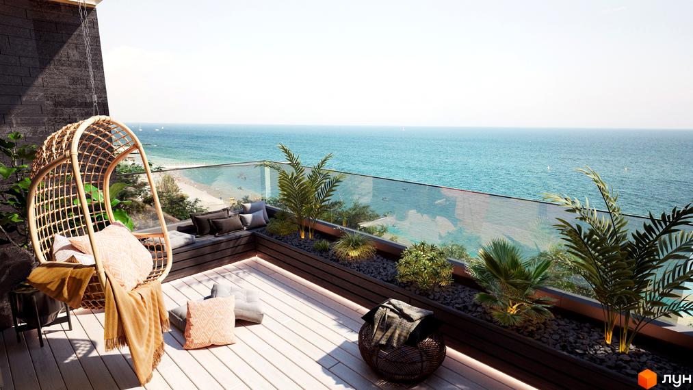 Балкон з плетеним кріслом та подушками, що виходить на море. Комплекс MAGNÍT. Будинок на Фонтані пропонує чудовий вид на узбережжя та відпочинкову зону.