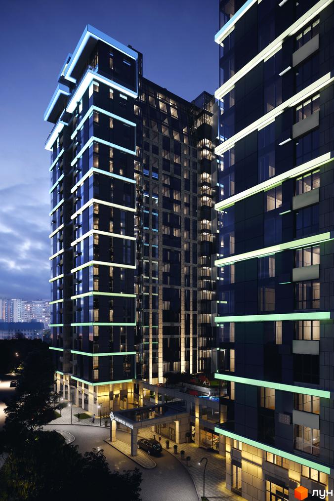 Житловий комплекс Edelweiss House: висотна новобудова з контрастним підсвічуванням поверхів у темний час доби. Прибудинкова територія з дорогою та входом.