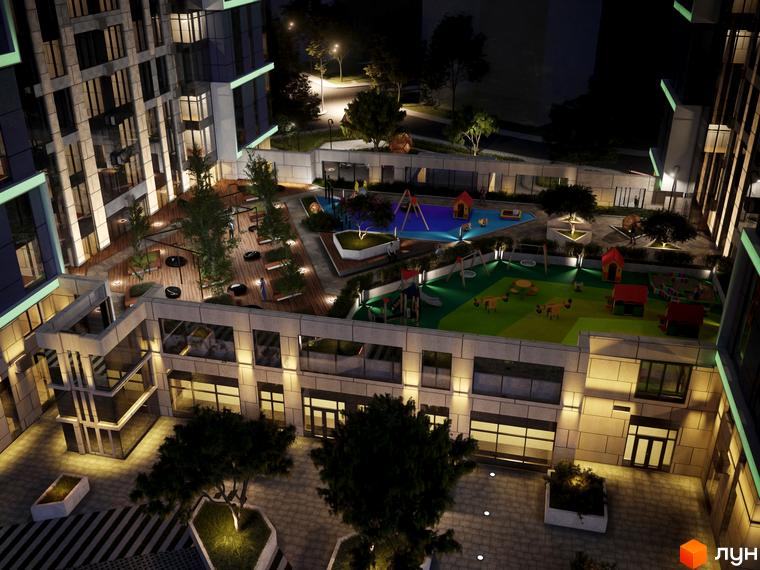 Житловий комплекс Edelweiss House з дитячими майданчиками та зонами відпочинку у вечірній час. Сучасна архітектура та освітлення території.