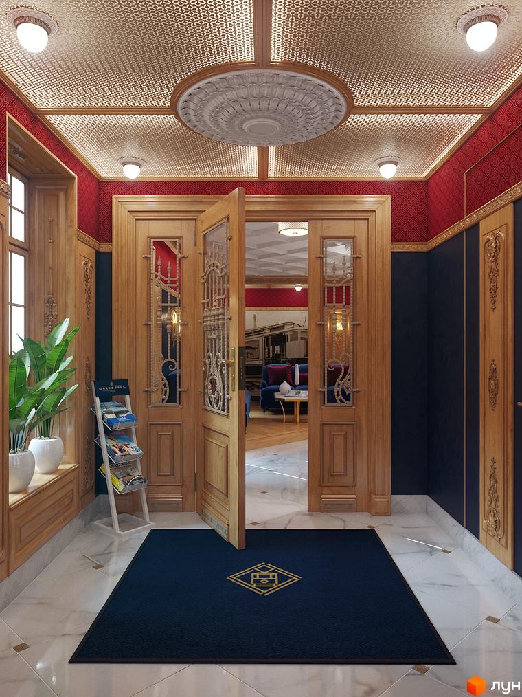 Вишуканий інтер'єр входу в ЖК Подол Град Vintage. Дерев'яні двері з вітражами, мармурова підлога та килим з логотипом комплексу створюють атмосферу розкоші.