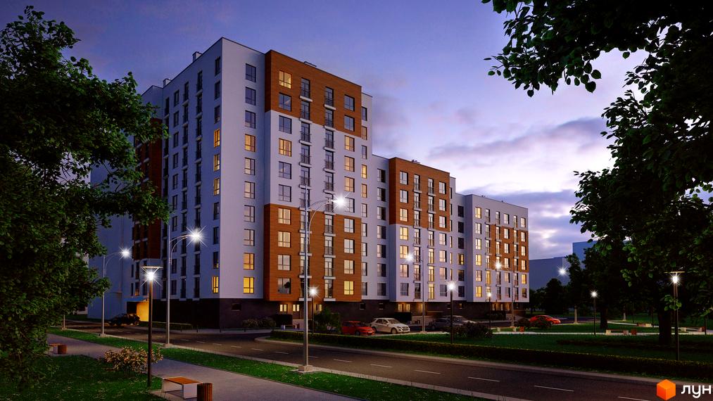 Житловий комплекс AUROOM TOWER з багатоповерховими будинками, що мають світлі та коричневі фасади. Вечірній вигляд з освітленими вікнами, дорогою, деревами та ліхтарями.