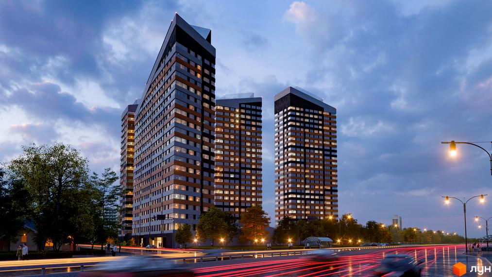 Житловий комплекс Terracotta: високі будинки з темними та світлими фасадами на тлі вечірнього неба. Освітлена дорога з рухом автомобілів та дерева навколо.