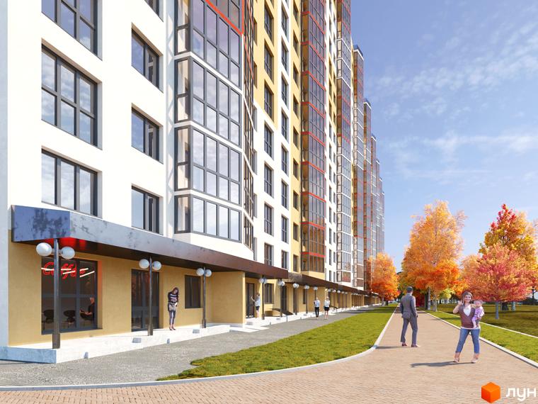 Багатоповерховий будинок житлового комплексу Привітний квартал. На передньому плані пішохідна алея з зеленими газонами та осінніми деревами.