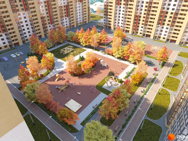 Житловий комплекс Привітний квартал. Високі будинки з жовтим фасадом. На території комплексу дитячий майданчик, алеї з лавками та осінні дерева.