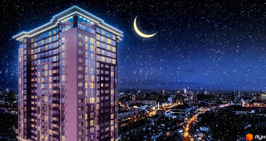 Житловий комплекс Victory V вночі зі снігом, що падає. Багатоповерховий будинок з підсвіченим фасадом та вікнами, що світяться, на тлі нічного міста та місяця.