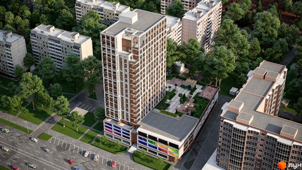 Аерофотографія Житлового комплексу Victory Hall: висотна будівля з світлим та коричневим фасадом, балконами. Поруч розташовані зелені насадження, дитячий майданчик на даху та парковка.