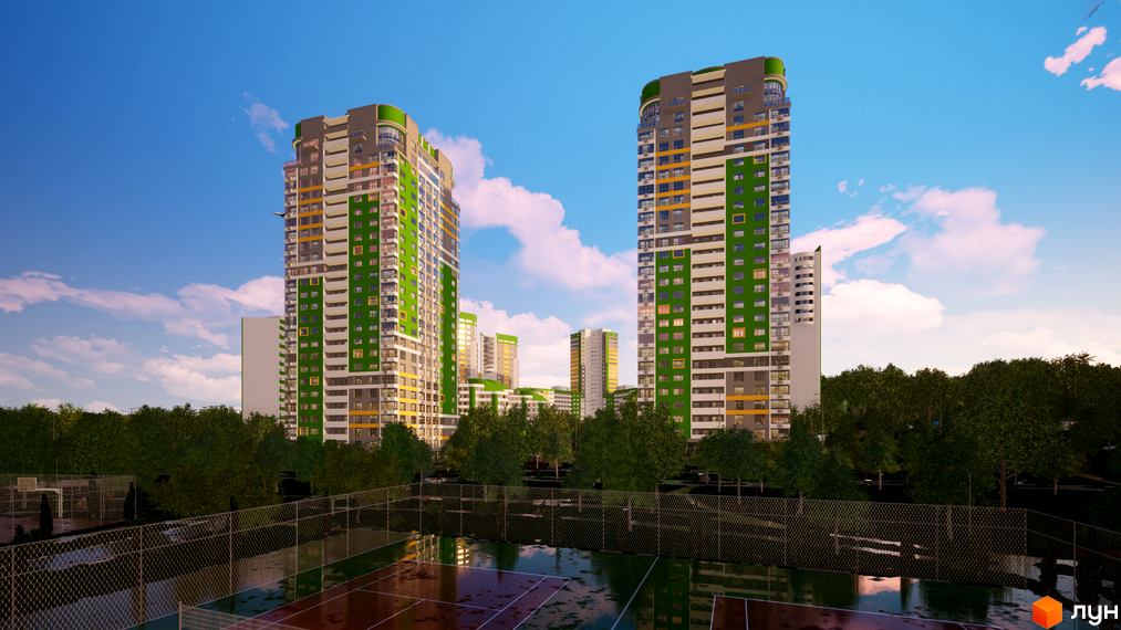 Високі житлові будинки Житлового комплексу Паркове місто з зеленими та сірими фасадами. Перед ними розташовані спортивні майданчики та багато дерев.