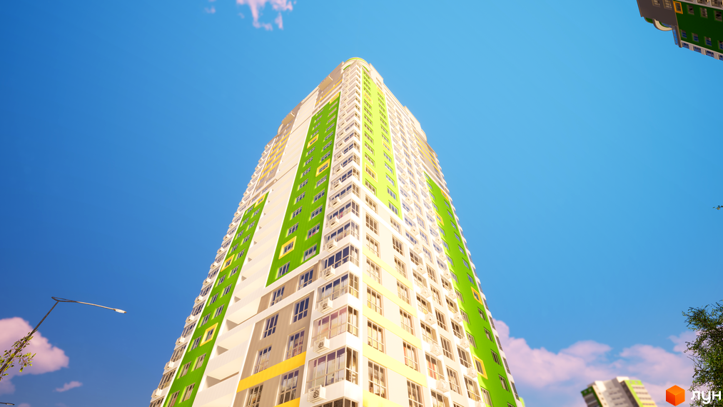 Висотна будівля Житлового комплексу Паркове місто з білим, зеленим та жовтим фасадом. Вид знизу на будинок на тлі блакитного неба з ліхтарем.