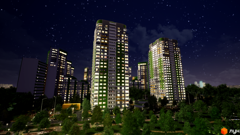 Житловий комплекс Паркове місто вночі, високі будинки з освітленими вікнами, фасади зеленого та сірого кольорів, навколо багато дерев та освітлені доріжки.