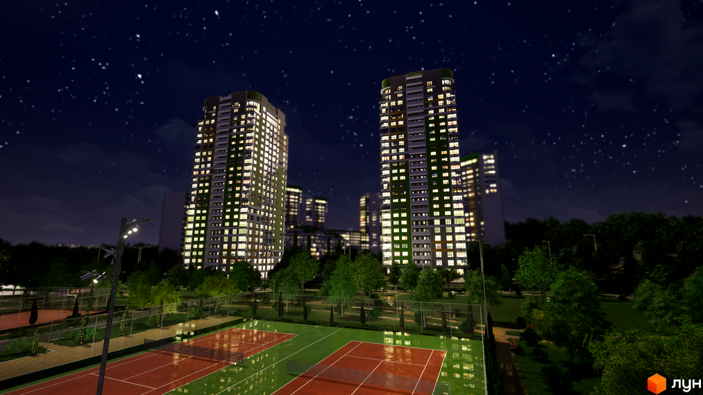 Житловий комплекс Паркове місто вночі: високі будинки з освітленими вікнами та тенісні корти на прибудинковій території серед дерев.
