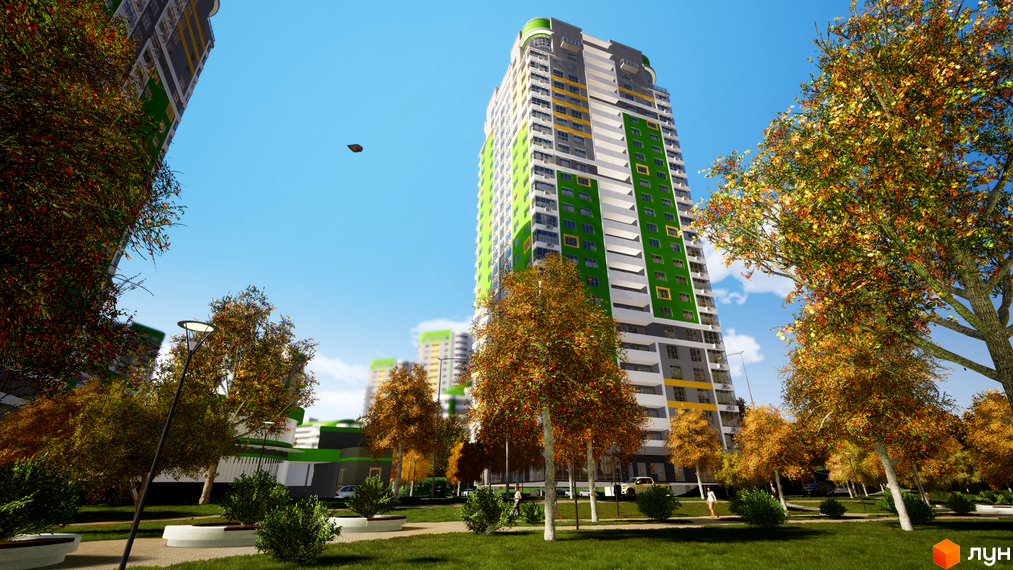 Житловий комплекс Паркове місто з висотною будівлею, що має фасади зеленого, білого та сірого кольорів. Прибудинкова територія облаштована газонами, осінніми деревами та ландшафтним дизайном.