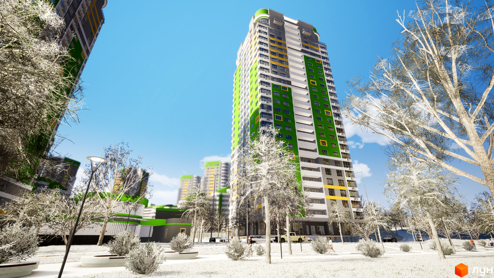 Багатоповерховий будинок Житлового комплексу Паркове місто з фасадом у зелених, сірих та жовтих кольорах. Прибудинкова територія вкрита білим покриттям, з деревами та лавками.