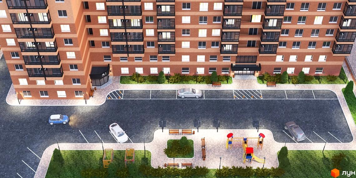 Висотна будівля ЖК Авіатор з цегляним фасадом, поруч парковка та дитячий майданчик. Благоустрій території для комфортного проживання.