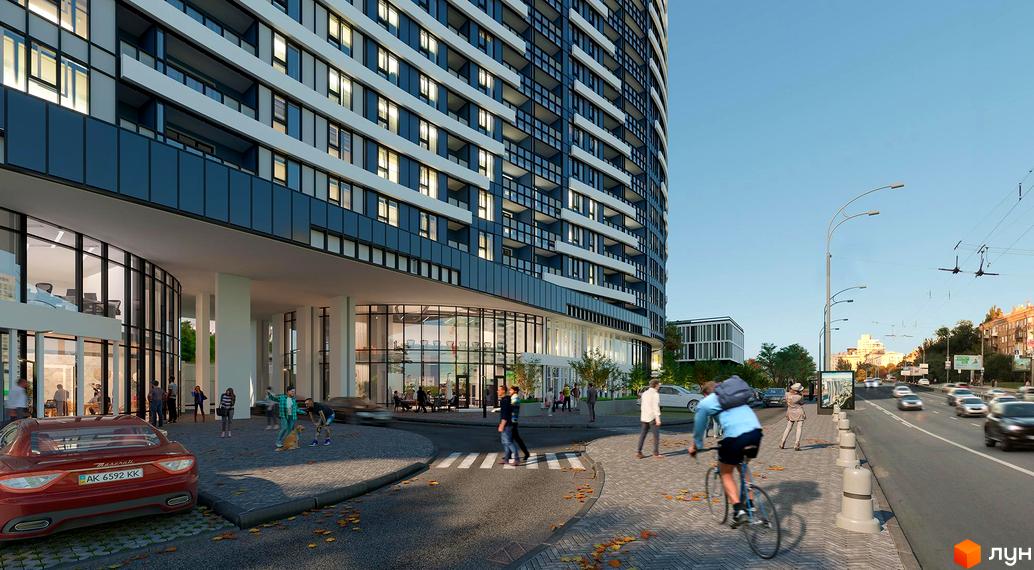 Житловий комплекс Aria з вигнутим фасадом та скляними елементами, розташований біля дороги з тротуаром та пішохідним переходом.