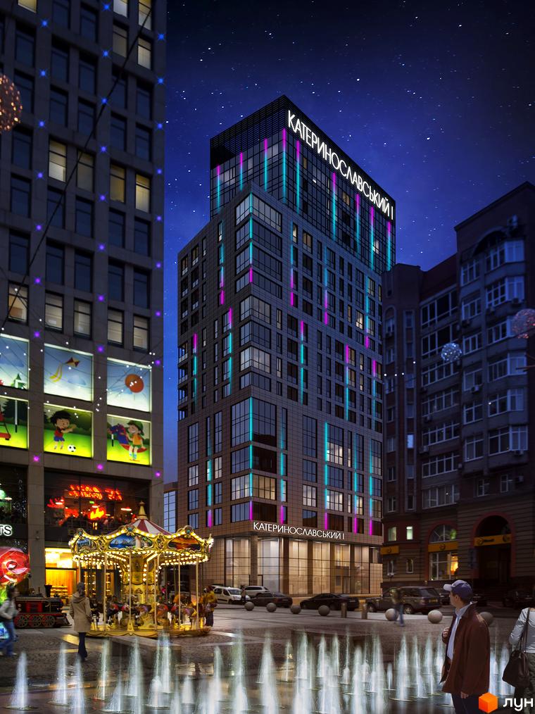 Висотна будівля ЖК Катеринославський I з яскравою підсвіткою на фоні нічного неба. На площі перед будинком розташований фонтан та карусель.