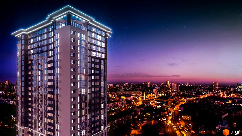 Сучасний житловий комплекс Victory V у вечірньому місті. Висотна новобудова з підсвічуванням та панорамними вікнами на тлі нічного неба.