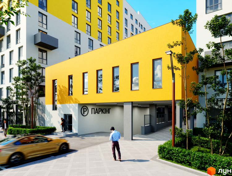 Житловий комплекс Riel City з жовтою фасадною частиною та сірими елементами, прибудинкова територія з деревами та автомобілем.
