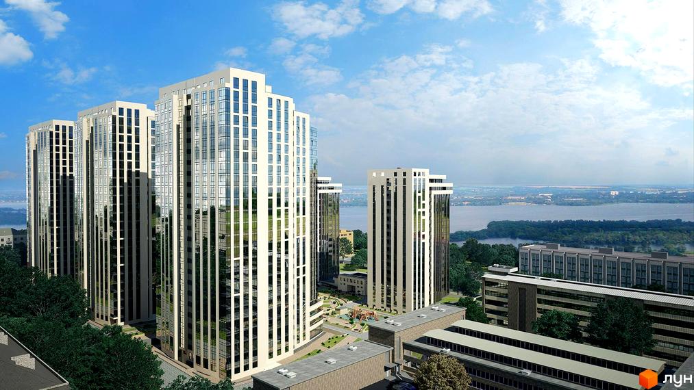 Високі білі будівлі житлового комплексу з панорамними вікнами. На прибудинковій території є зелені насадження та дитячий майданчик.