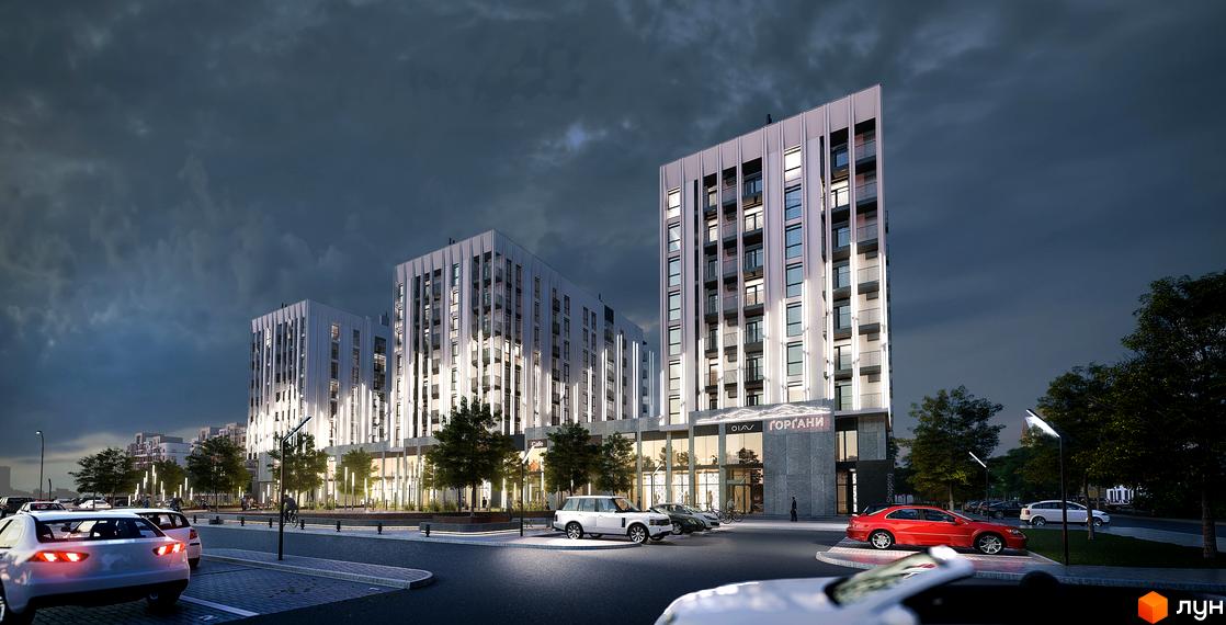 Житловий комплекс Ґорґани: сучасна архітектура з вертикальним освітленням та доглянутою прибудинковою територією з парковкою та деревами.