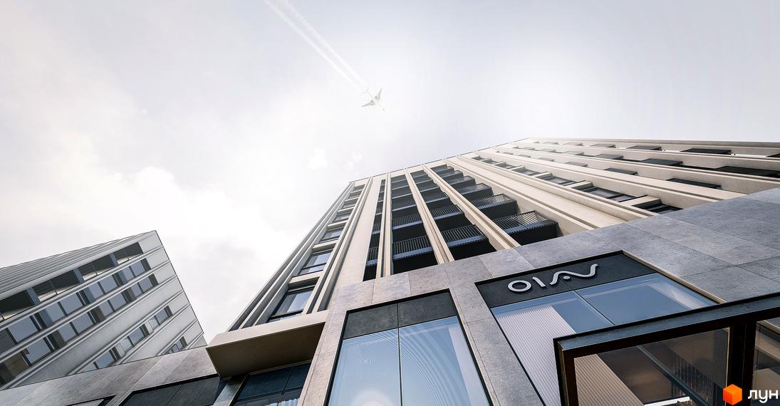 Сучасний житловий комплекс Ґорґани з багатоповерховими будинками та балконами. Вид знизу на будівлі та небо з літаком.