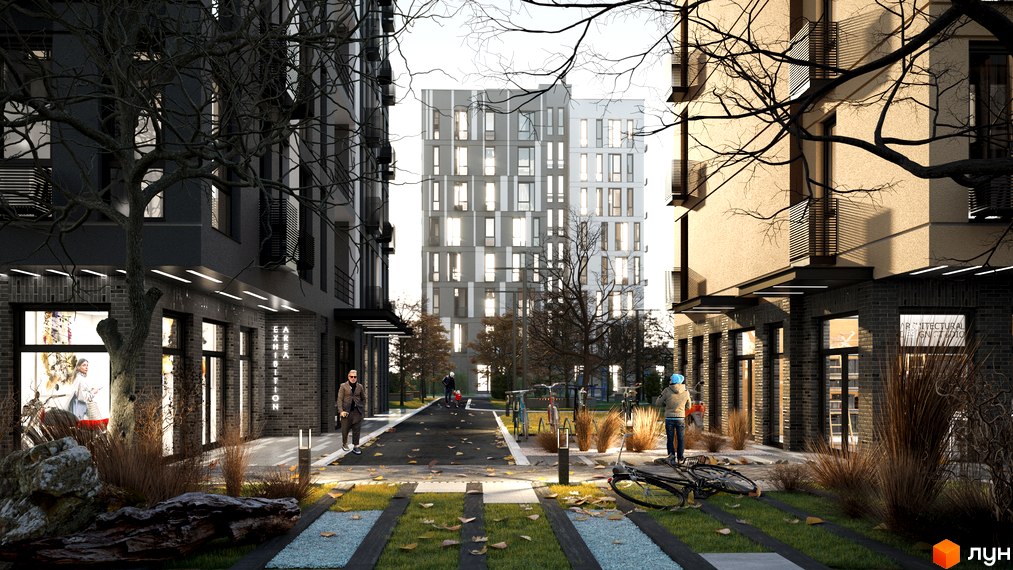 Зовнішній вигляд житлового комплексу ATRIA CITY. TEREMKY з фасадами різних кольорів та прибудинковою територією з деревами та велосипедами.