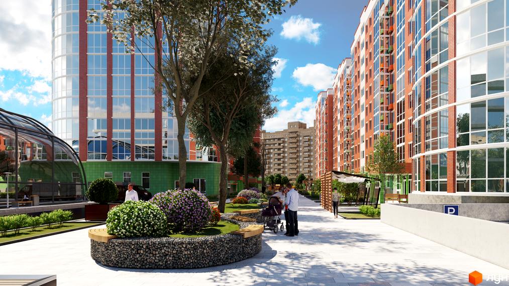 Зовнішній вигляд житлового комплексу Райдужний з цегляним фасадом та скляними елементами, а також доглянутою прибудинковою територією з квітами та деревами.