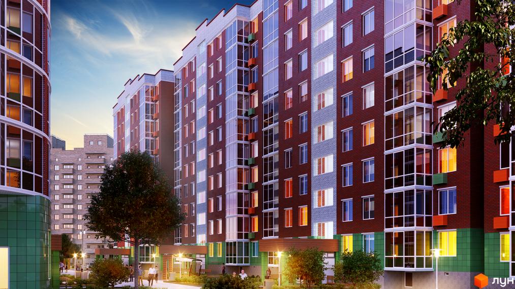 Зовнішній вигляд багатоповерхових будинків житлового комплексу Райдужний з цегляним фасадом та панорамними вікнами. Територія навколо будинків з деревами та освітленням.