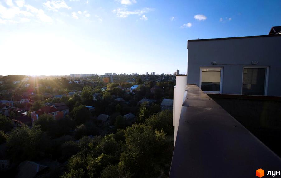 Вид на житловий комплекс Панорама з висоти пташиного польоту. Сучасна архітектура будинку та зелена прибудинкова територія.