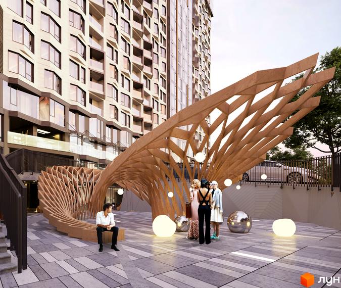 Багатоповерховий будинок з великими вікнами та світлим фасадом. Перед ним розташована дерев'яна архітектурна конструкція та освітлені сфери на брукованій площі Житлового комплексу Fjord.