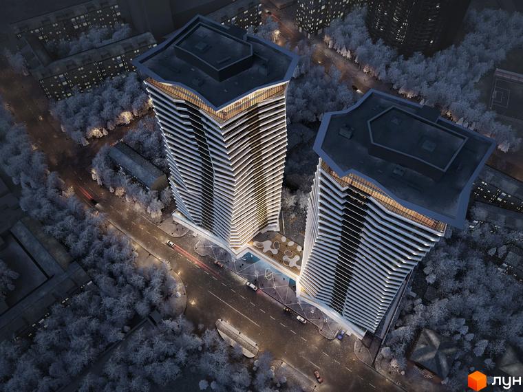 Комплекс Diadans - висотні будівлі з хвилястими фасадами, що світяться вночі. Навколо - засніжені дерева та міська вулиця з автомобілями.