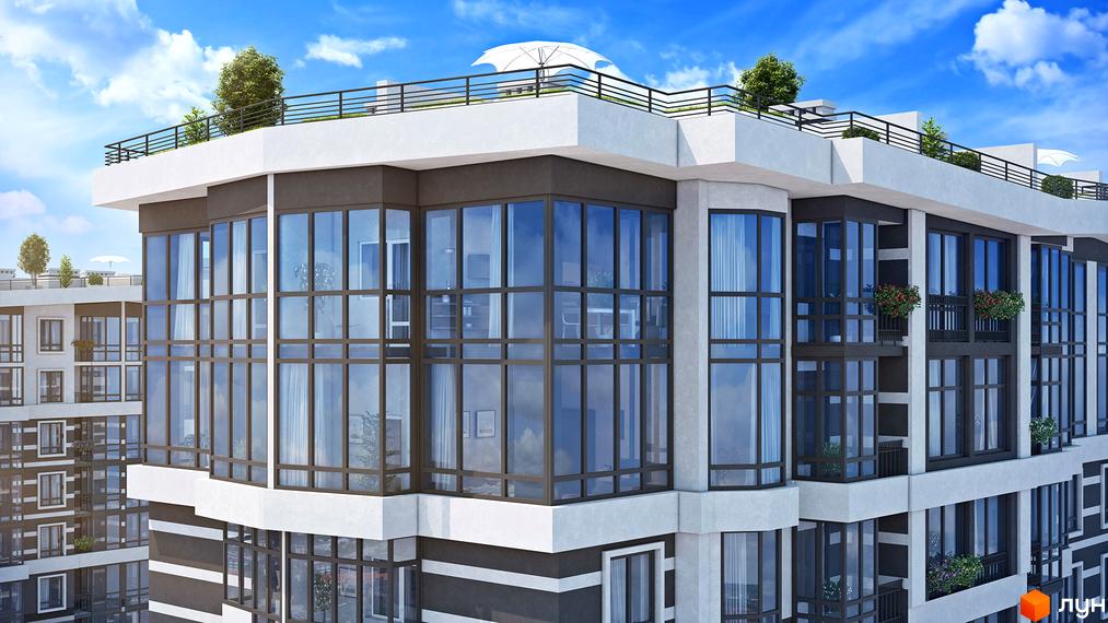 Зображення фасаду Новобудови Гранд Бурже з великими вікнами та терасою на даху. Вигляд багатоповерхового будинку на фоні блакитного неба.