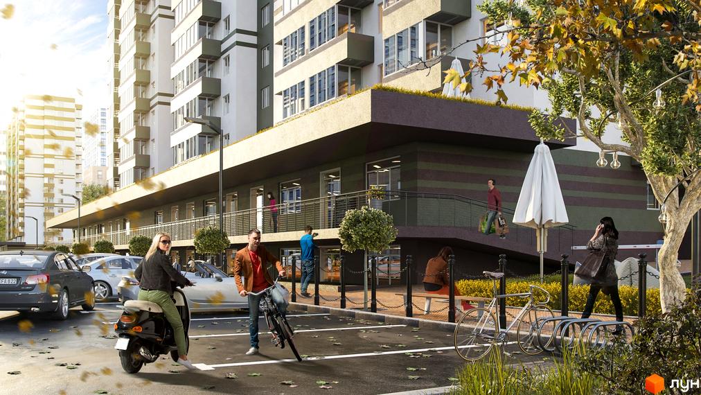 Зображення фасаду Житлового комплексу Набережний та прибудинкової території. На передньому плані парковка з автомобілями та людьми.