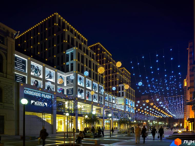 Житловий комплекс Cascade Plaza з сучасною архітектурою та освітленням. Прибудинкова територія з декоративними елементами та освітленням.