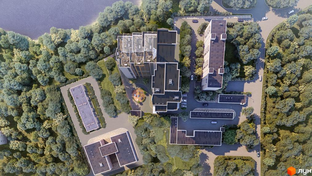 Житловий комплекс LAKE HOUSE: вид зверху на будівлі різної поверховості з темними дахами та прибудинкову територію, яка оточена зеленню.