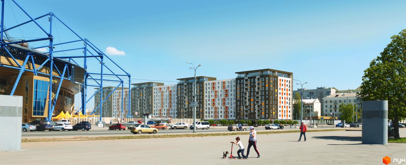Житловий комплекс Спортивний: фасади будівель з білими, сірими та помаранчевими елементами, панорамні вікна. Поруч стадіон, дорога з автомобілями та люди на вулиці.