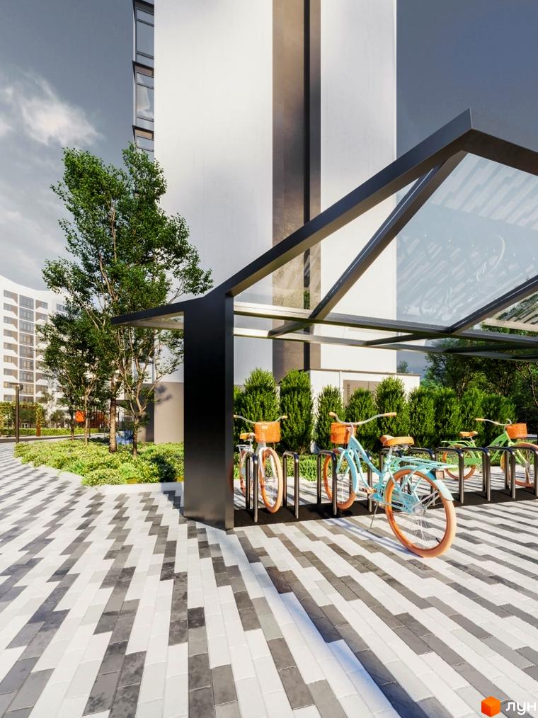Житловий комплекс Авіатор: сучасна архітектура та доглянута прибудинкова територія з велопарковкою. Зелені насадження та зручні доріжки для мешканців.