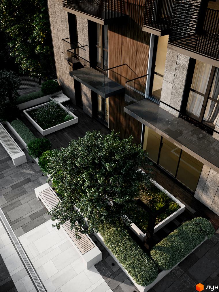 Зовнішній вигляд новобудови ЖК Бісквітний з елементами природного озеленення та місцями для відпочинку на прибудинковій території.