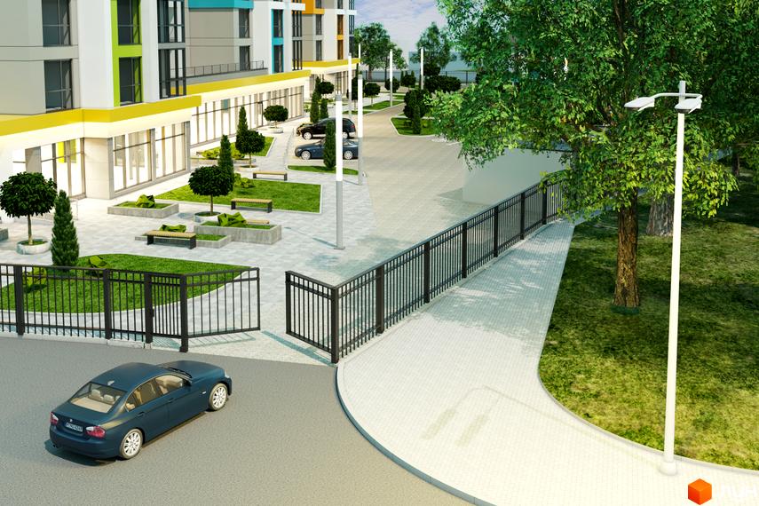 Зображення фасаду будівлі ЖК Південний з прилеглою територією: паркуванням, газонами, деревами та лавками.