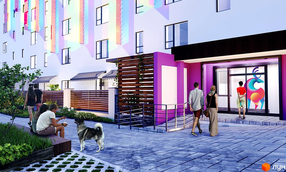 Фасад будівлі житлового комплексу Синергія Glass з панорамними вікнами та яскравими кольоровими елементами. На передньому плані люди та собака на території комплексу.