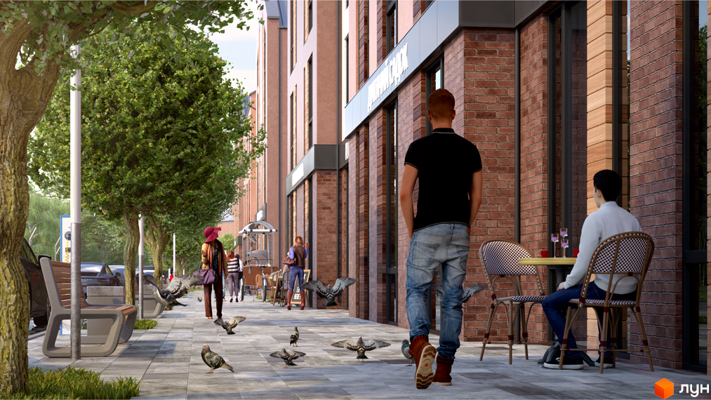 Зовнішній вигляд житлового комплексу Viking Home з цегляним фасадом та прибудинковою територією з деревами та лавками. На зображенні також видно людей, що прогулюються.