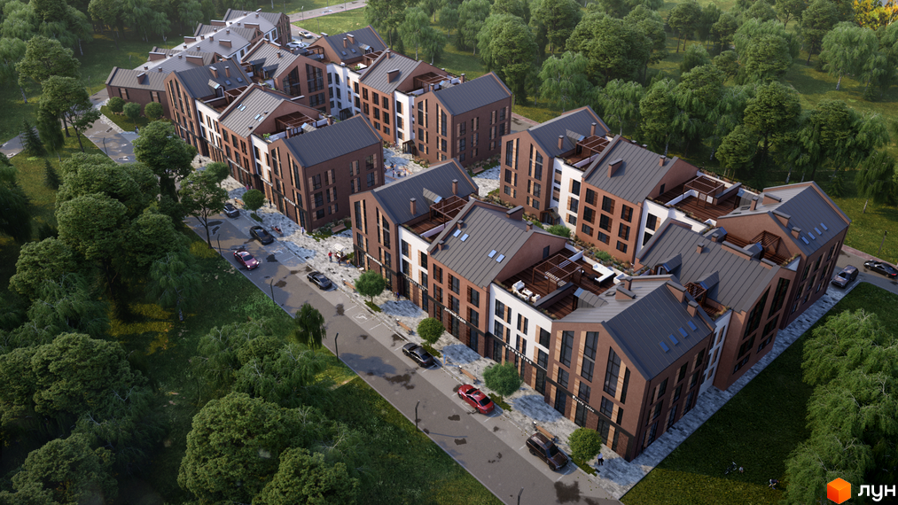 Житловий комплекс Viking Home з коричневою цегляною фасадною частиною та сірими дахами, оточений зеленою територією з деревами та дорогою з автомобілями.