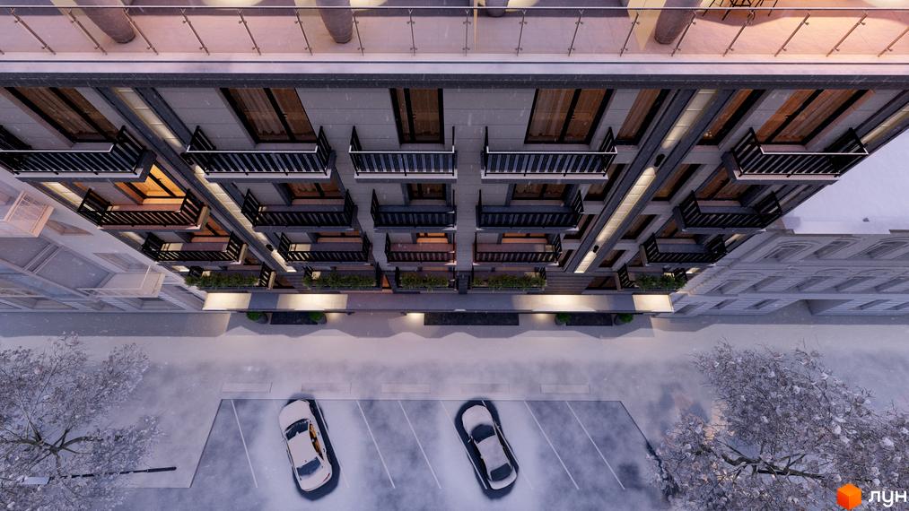 Зовнішній вигляд ЖК Apart Royal з балконами та парковкою. Новобудова з прибудинковою територією в зимовий період.