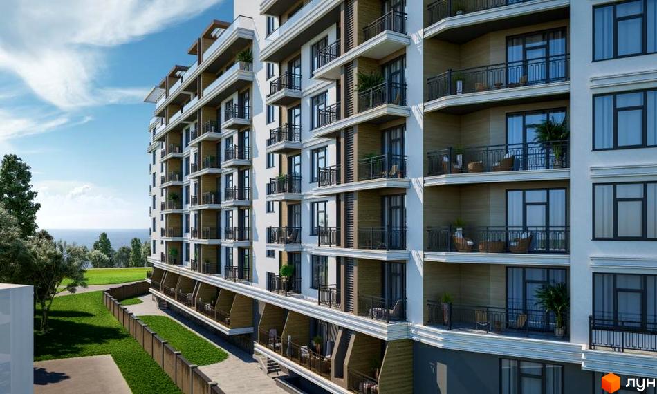 Новобудова MARINIST residence з білим фасадом, темними вікнами та балконами. Навколо будинку зелені газони, дерева та вид на море.