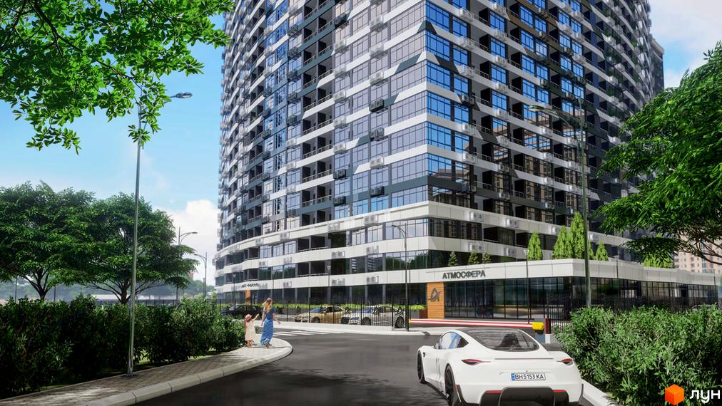 Висотна будівля житлового комплексу Атмосфера з великою кількістю вікон. На передньому плані дорога та зелені насадження.