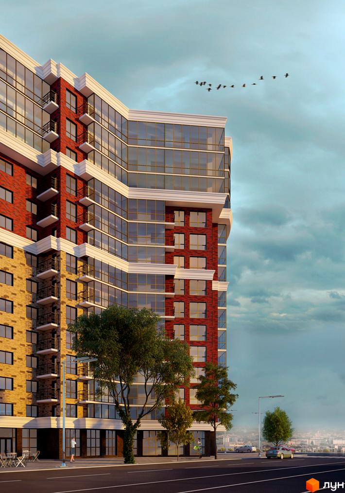 Зовнішній вигляд новобудови ЖК Яровиця з цегляним фасадом та панорамним склінням. Поруч дорога, дерева та міський пейзаж.