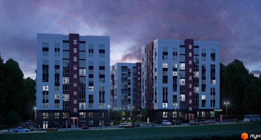 Зовнішній вигляд житлового комплексу Рідний у вечірній час, з освітленими вікнами та прибудинковою територією з деревами та ліхтарями.