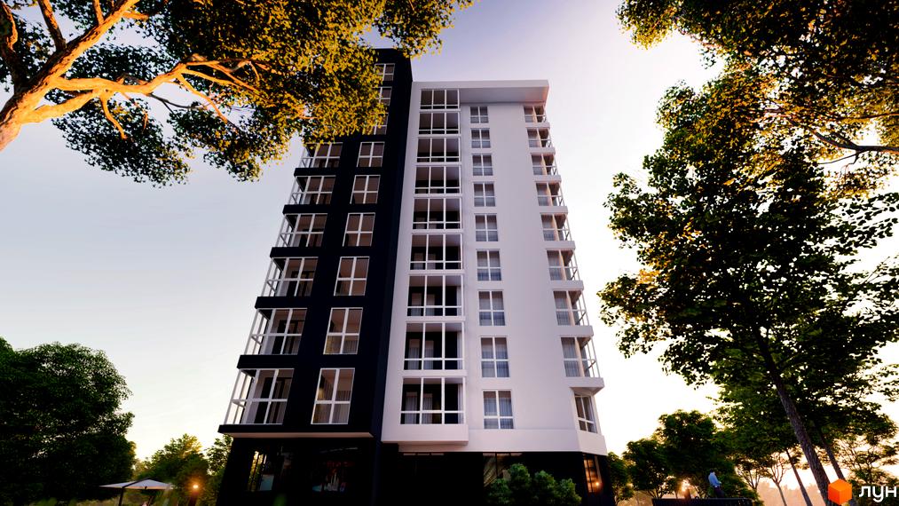 Фасад житлового комплексу Kaiser Park, що складається з двох частин: чорної та білої. Навколо будівлі зелені дерева та елементи прибудинкової території.